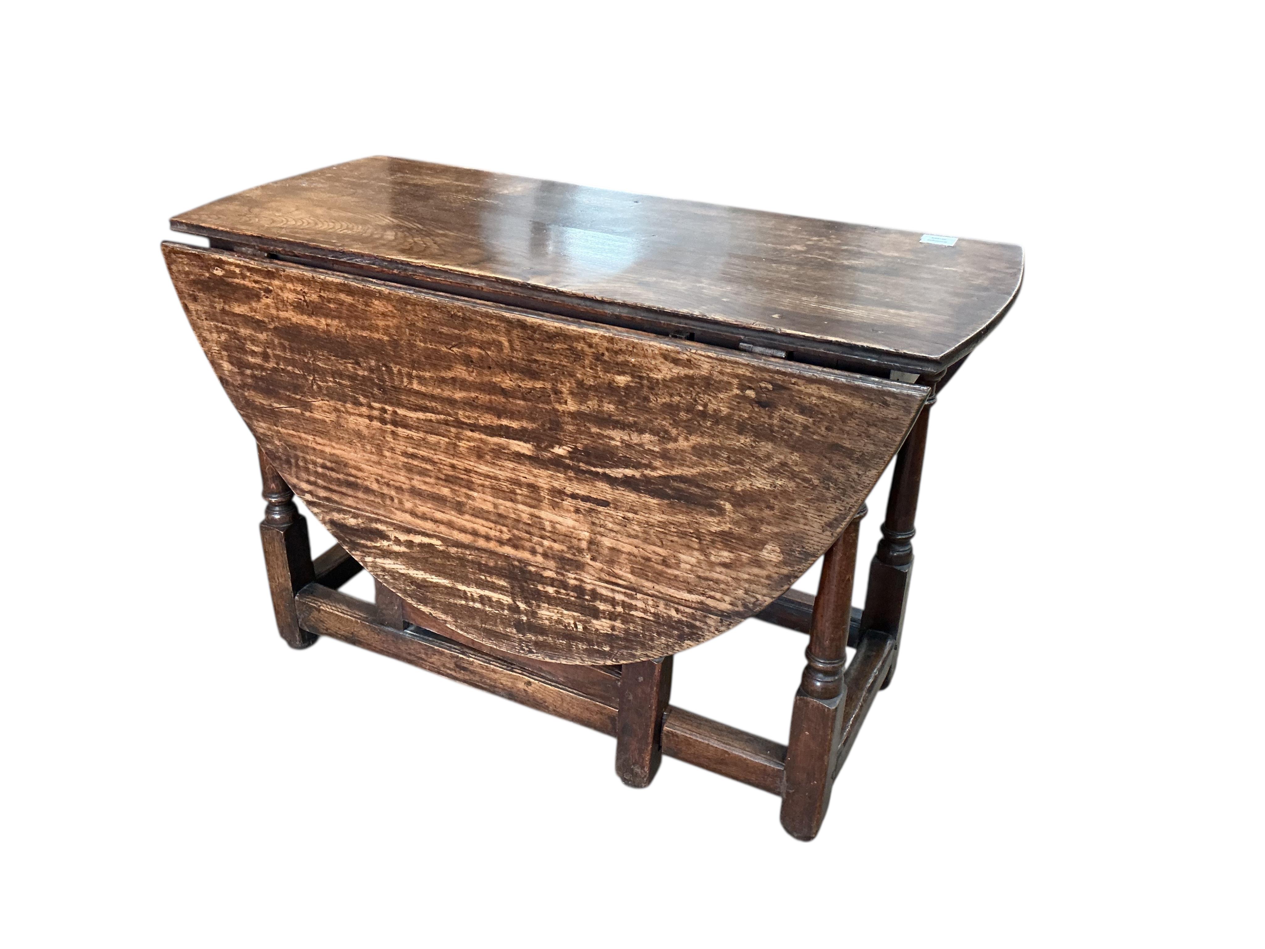 An early 18th century oak gateleg table, width 104cm, depth 47cm, height 69cm